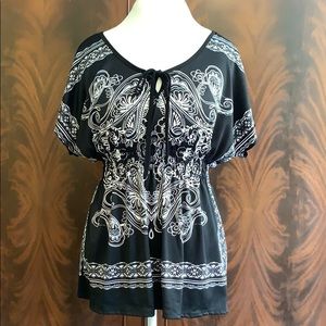 Black and white printed shirt with cinched waist.